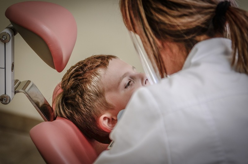 dentist performing tooth extraction