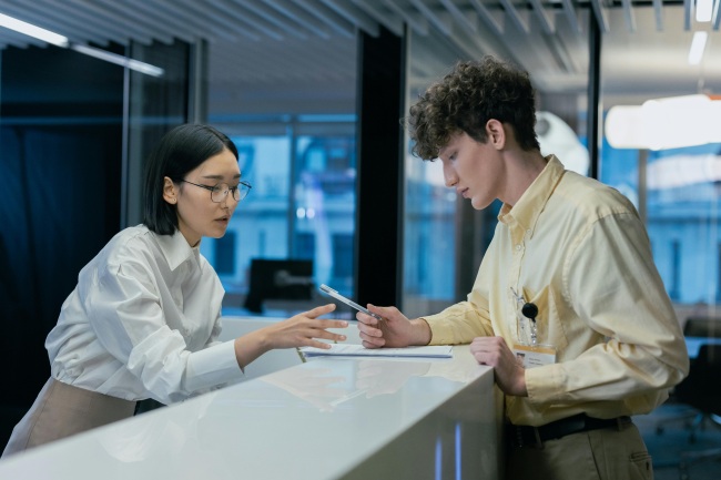 receptionist in the office assisting a walk in client